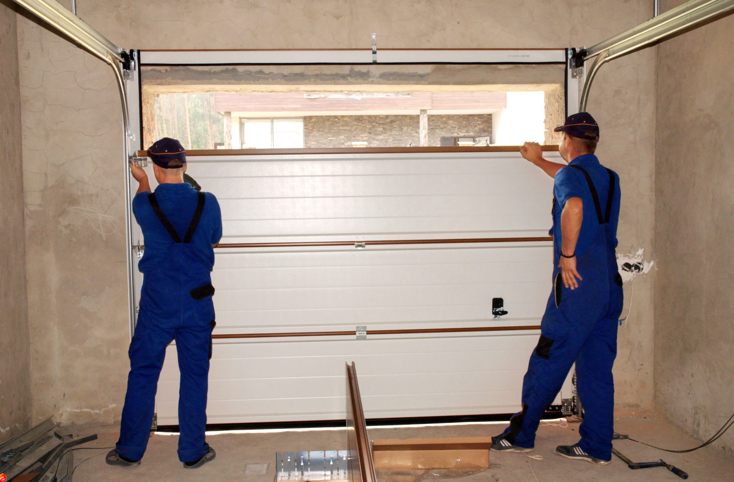 Technician working on a residential garage door and opener